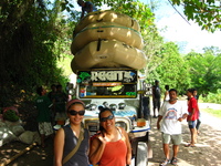 Marebec and Tanya standing in front of a jeepney with three rafts piled on its roof.