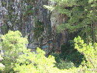 Wooden coffins hanging on a cliff face.