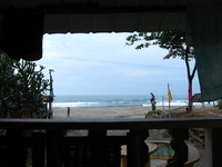 A beach seen from the veranda of a hotel room.