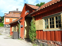 A single-storey wooden building with an archway leading through to the back.