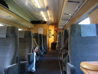 In first class on the X2000. The interior of a first-class railway carriage, decorated in muted colours and wood panelling.