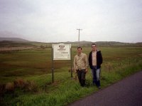 Matt and Dugly standing beside the Laphroaig disillery sign